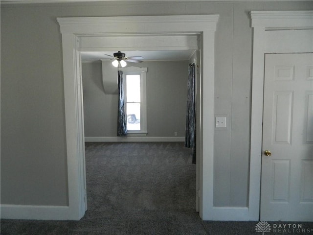 hallway with dark colored carpet