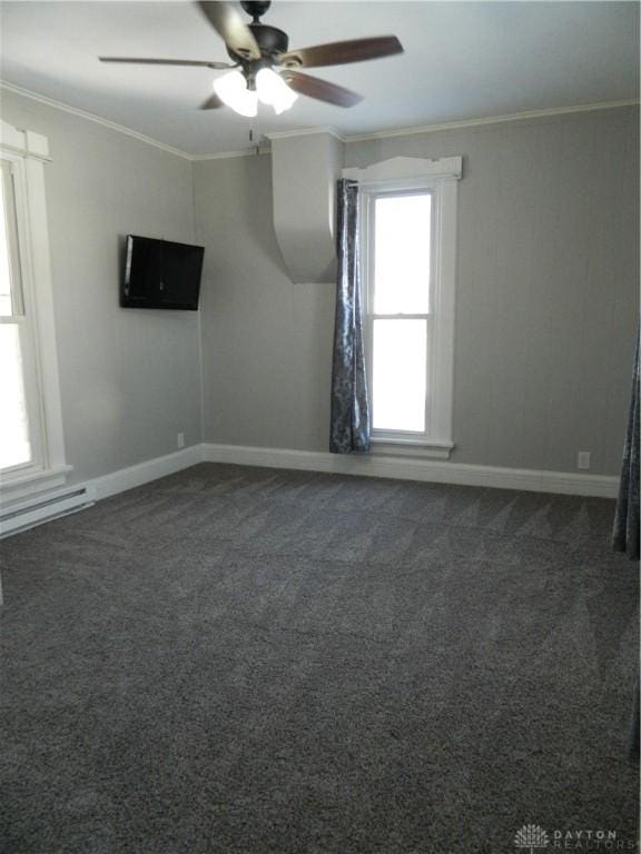 carpeted spare room featuring ornamental molding, ceiling fan, and a baseboard heating unit