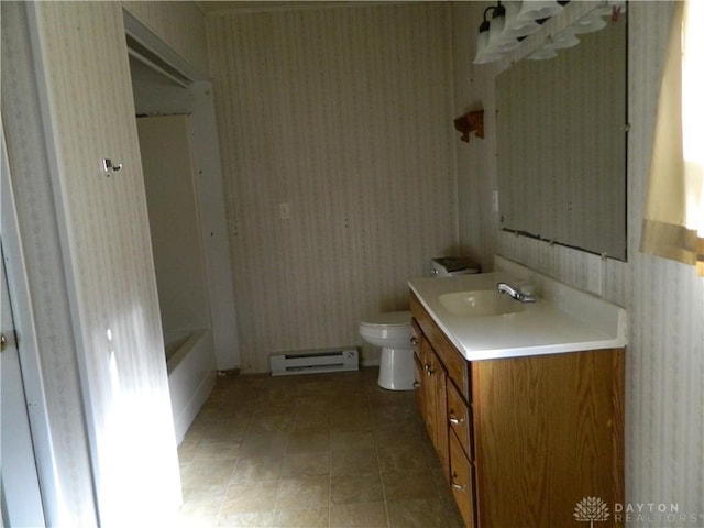 bathroom featuring a bath, baseboard heating, vanity, and toilet