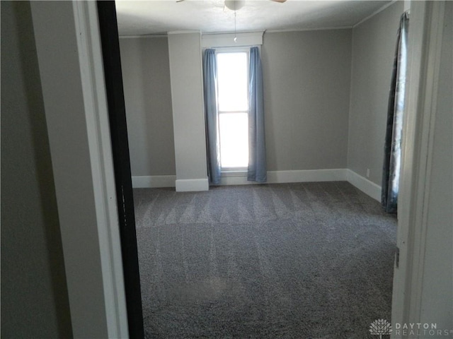 unfurnished room with ceiling fan, crown molding, and carpet