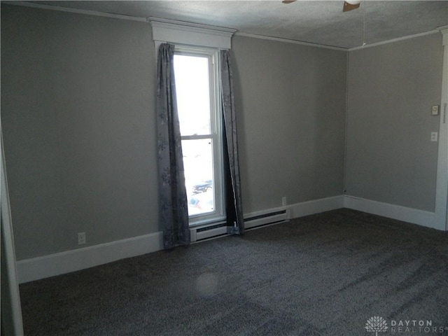 empty room featuring a textured ceiling, ornamental molding, ceiling fan, and baseboard heating