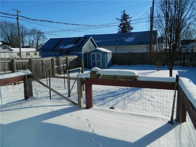 snow covered deck featuring a shed