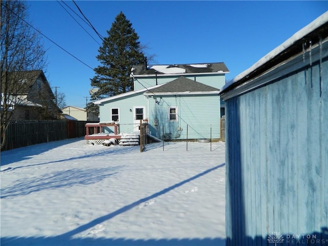 snow covered property featuring a jacuzzi