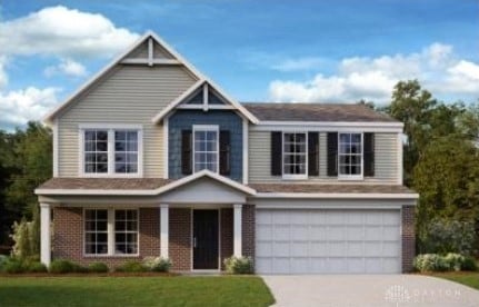 craftsman-style house featuring a front lawn and a garage