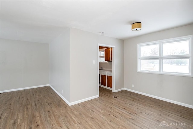 spare room with hardwood / wood-style floors