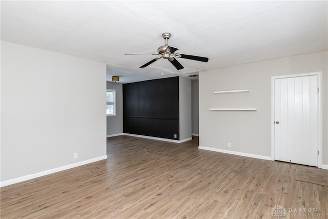 empty room with ceiling fan and light wood-type flooring