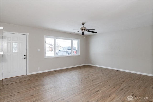 foyer entrance with hardwood / wood-style flooring and ceiling fan