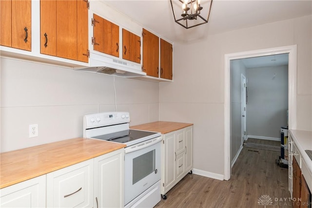 kitchen with wood-type flooring, a chandelier, and white range with electric cooktop