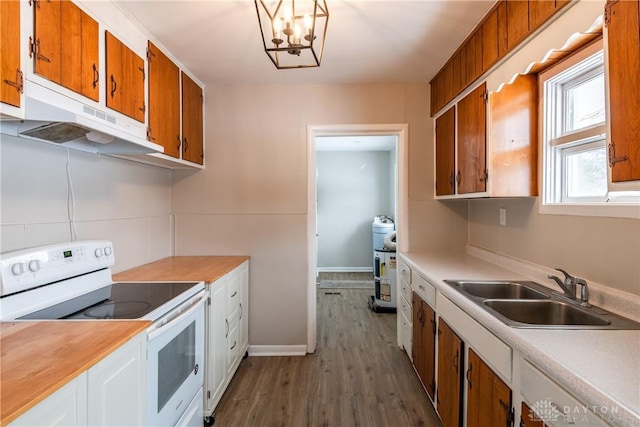 kitchen with sink, white electric stove, dark hardwood / wood-style floors, and a chandelier