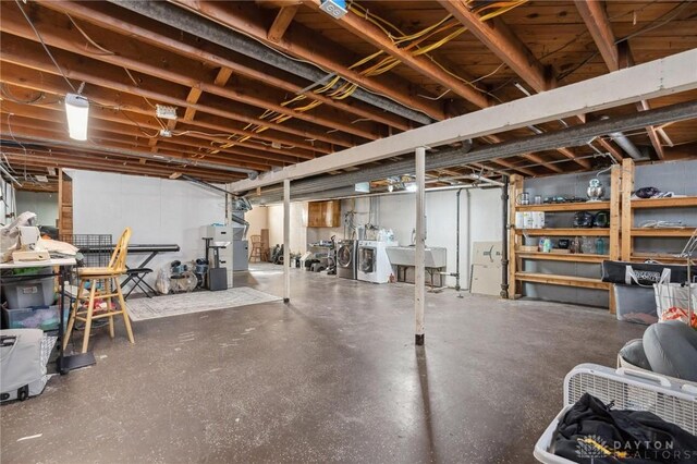 basement with sink and washer and clothes dryer