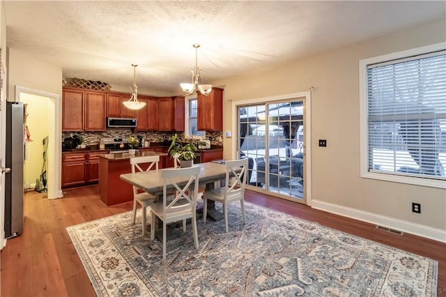 dining room featuring a chandelier and light hardwood / wood-style flooring