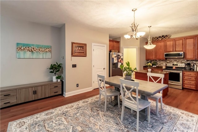 dining space with a notable chandelier and dark hardwood / wood-style floors