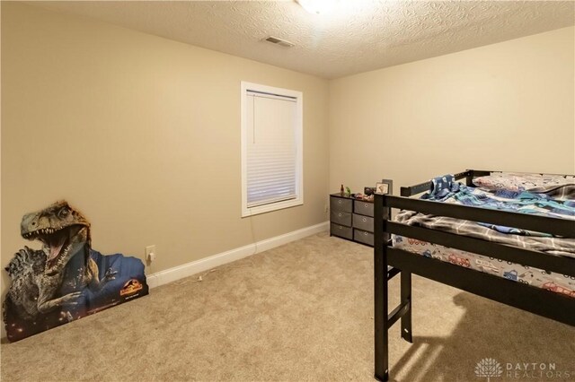 carpeted bedroom with a textured ceiling