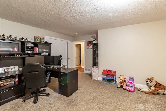 office featuring a textured ceiling and carpet