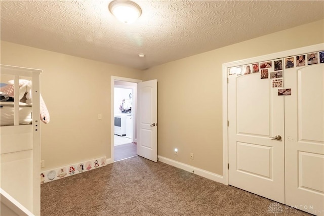 unfurnished bedroom with carpet flooring, a closet, and a textured ceiling