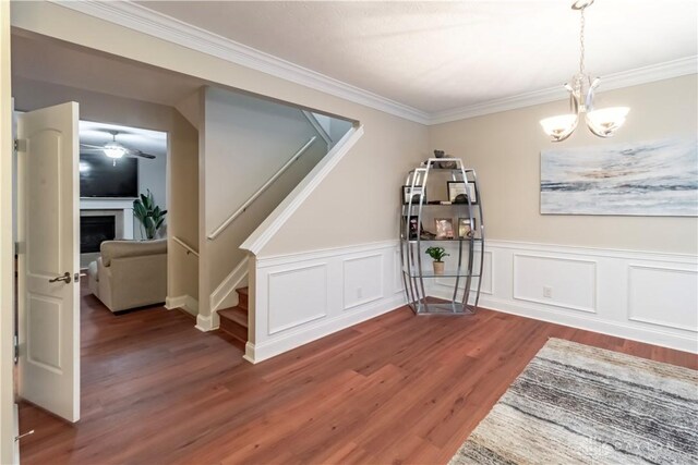 dining area with a notable chandelier, dark hardwood / wood-style flooring, and ornamental molding