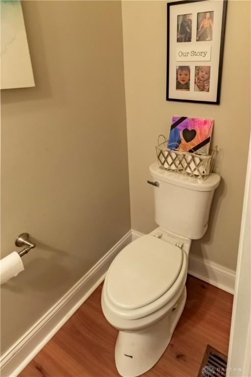 bathroom with toilet and hardwood / wood-style flooring