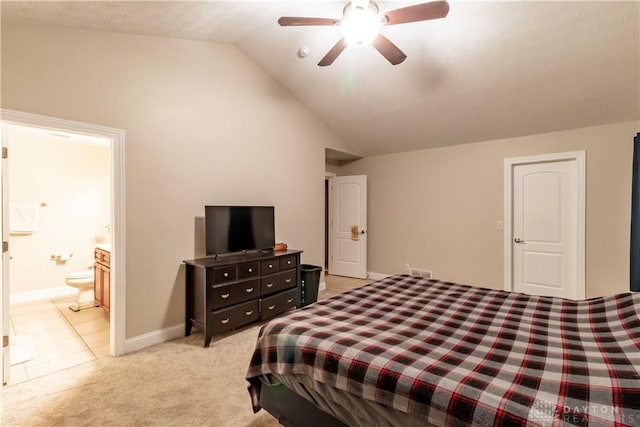 carpeted bedroom featuring ensuite bath, ceiling fan, and vaulted ceiling