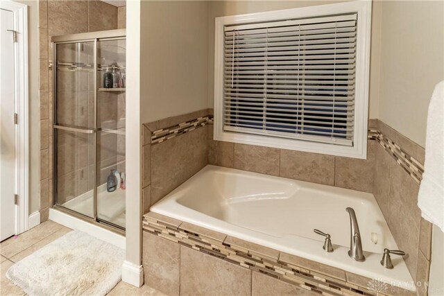 bathroom with tile patterned flooring and plus walk in shower