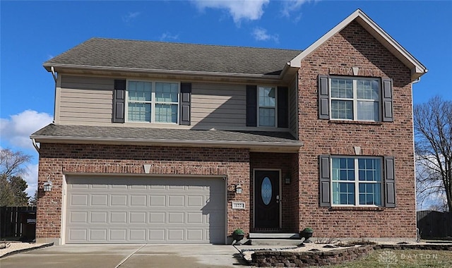 traditional home with an attached garage, driveway, and a shingled roof