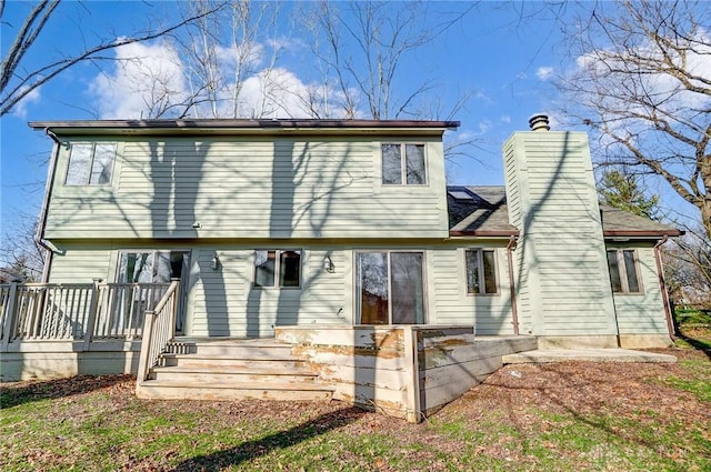 rear view of house featuring a wooden deck