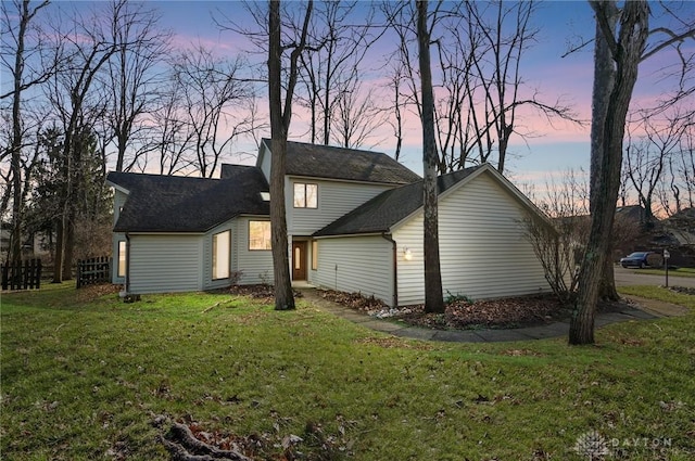 back house at dusk with a yard