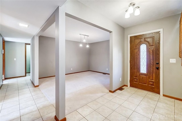 view of carpeted foyer entrance