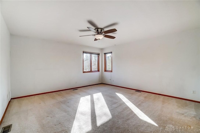 empty room with ceiling fan and light colored carpet