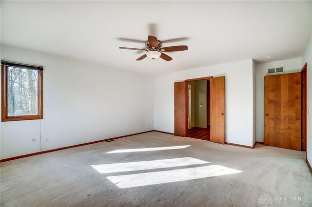 unfurnished bedroom featuring ceiling fan and light carpet