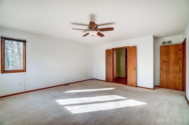 unfurnished bedroom featuring ceiling fan and light carpet