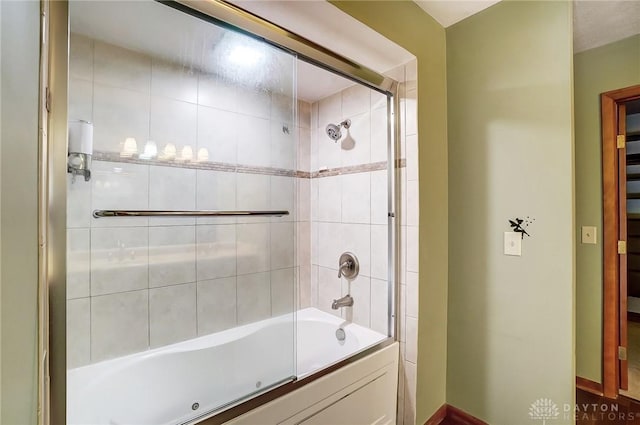 bathroom with shower / bath combination with glass door