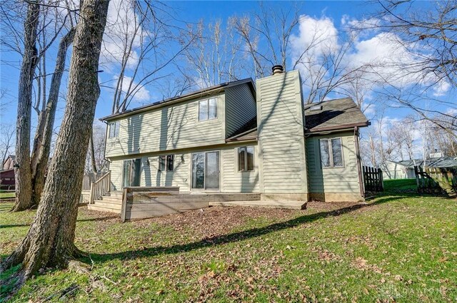 back of property featuring a lawn and a patio