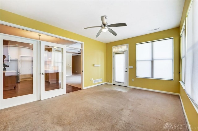 interior space with ceiling fan and french doors