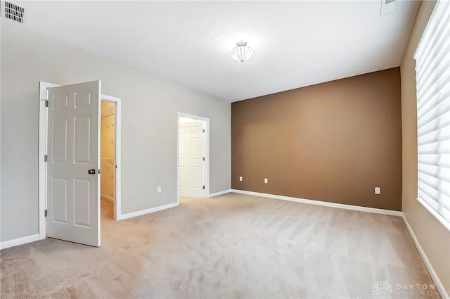 unfurnished bedroom with light colored carpet