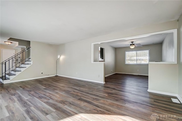 unfurnished living room with ceiling fan and dark hardwood / wood-style flooring