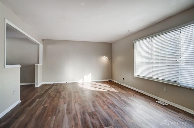 unfurnished living room featuring dark wood-type flooring