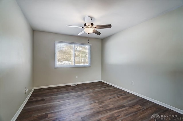 empty room with ceiling fan and dark hardwood / wood-style floors