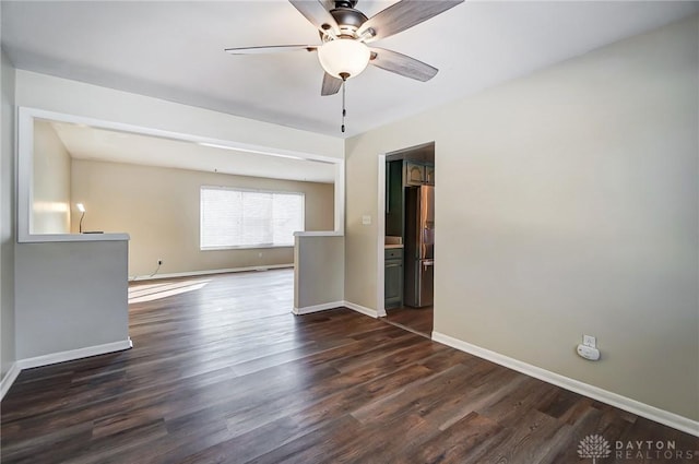 unfurnished room featuring ceiling fan and dark wood-type flooring