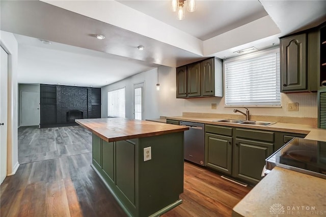 kitchen with wood counters, a brick fireplace, a center island, stainless steel dishwasher, and sink