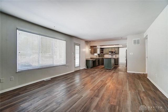 unfurnished living room featuring dark wood-type flooring