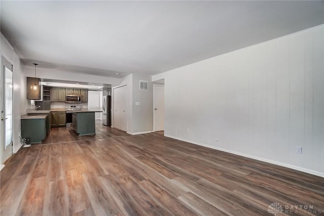 unfurnished living room with dark hardwood / wood-style floors and sink