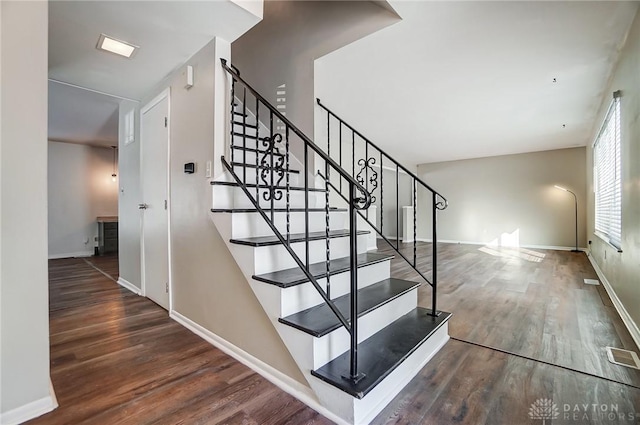 staircase featuring wood-type flooring