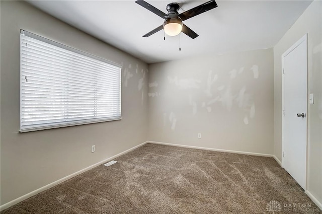 empty room with carpet floors and ceiling fan