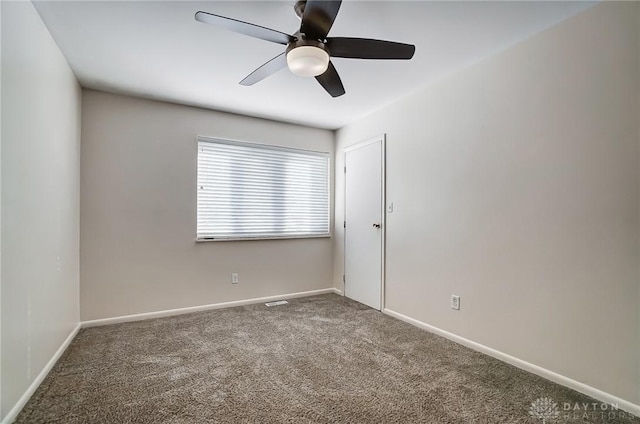 carpeted spare room featuring ceiling fan