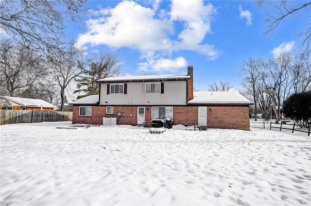 view of snow covered rear of property