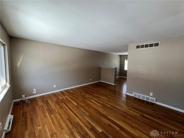 spare room featuring dark hardwood / wood-style floors