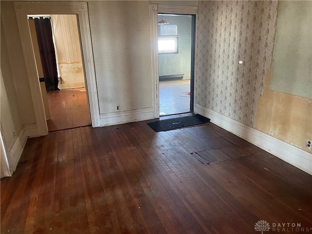 spare room with dark hardwood / wood-style floors