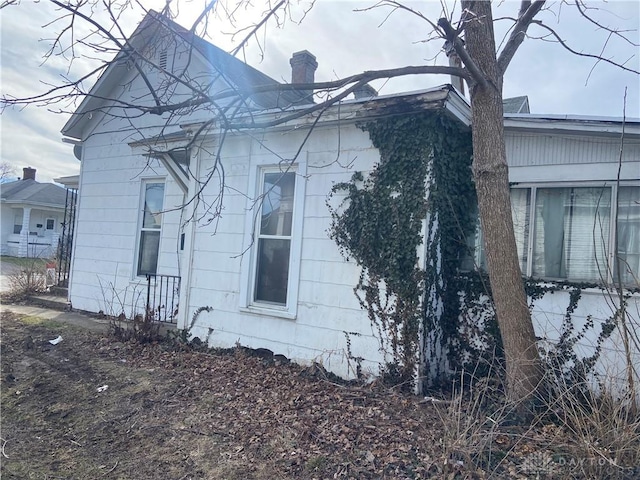 view of side of property with a chimney