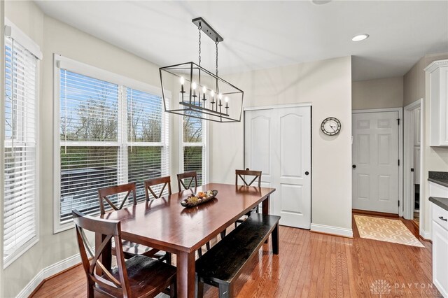 dining space featuring plenty of natural light, a notable chandelier, and light hardwood / wood-style flooring