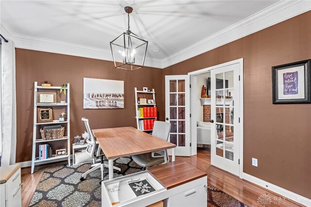 home office featuring french doors, an inviting chandelier, ornamental molding, and light hardwood / wood-style flooring